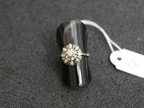 an image of a silver ring with a flower on top of it