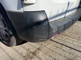 the rear end of a white truck parked on the side of the road