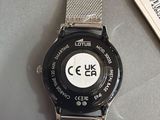 a watch that is sitting on a table next to a tag