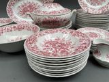 a lot of plates and bowls that are sitting on a table