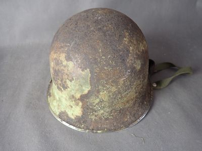 an old helmet with a green paint on it