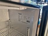 a small refrigerator with its door open in a kitchen