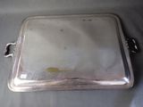 a silver tray with a handle on it on a table