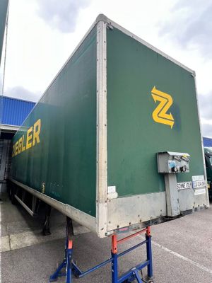 a green box truck parked in a parking lot