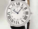 the watch is white with roman numerals and black leather straps