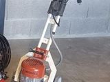 a machine that is sitting on the floor next to a hose