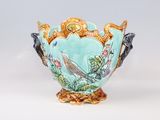 a vase with a bird on it sitting on a table