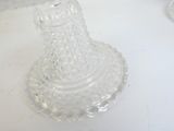 a clear glass candle holder sitting on a white table