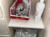 a picture of a bathroom with a trash can in the corner