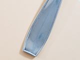 a silver spoon with a blue handle on a beige surface