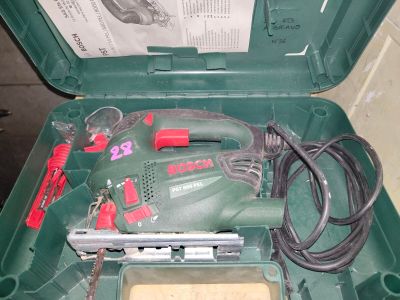 a green box with tools inside of it on the floor
