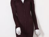 the mannequin is wearing a maroon dress and black hat