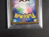 a close up of a pokemon card on a black surface