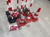 many red and white cones on the ground next to each other