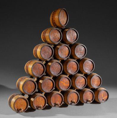 wooden wine barrels stacked on top of each other in a pyramid