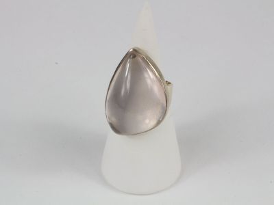 silver ring with a tear shaped stone on top of a white cone