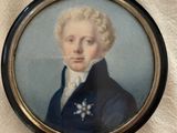 portrait of a young man in a blue coat and white shirt