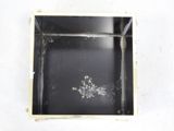 a picture of a black box with a small hole in it