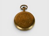 an old gold pocket watch with a picture of a man on it
