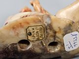 a close up of a carved animal head on a table