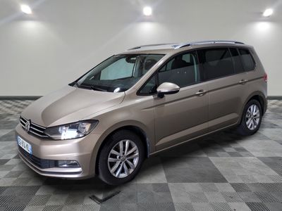 the volkswagen touran is parked in a large room with a checkered floor