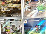 four pokemon cards are shown in a row on a table