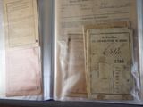 a folder of papers and a book on a table