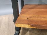a close up of a wooden table with metal legs