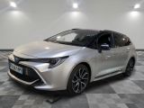 the silver toyota corolla is parked in a room with a checkered floor