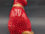 a red cat figurine sitting on top of a table