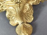 a gold figurine that is sitting on a table