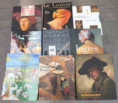 several books are sitting on the floor next to each other