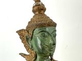 bronze statue of a person with a bird on top of his head