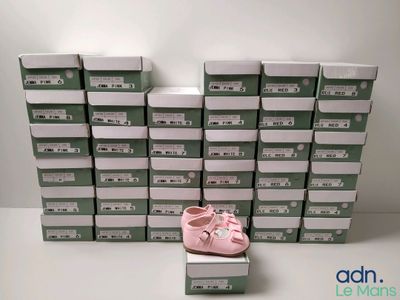 a lot of boxes of baby shoes on the floor
