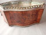 a wooden box with a mirror in it on a table