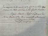 an old document with writing on it sitting on a table