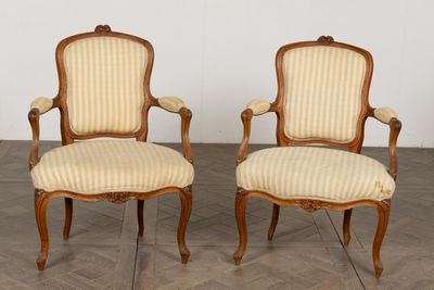 pair of louis xv style carved wood armchairs with upholstered upholstered arms