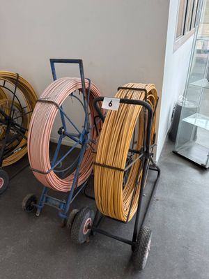 many different types of hoses on a cart in a room