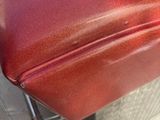 a close up of a red leather seat on a motorcycle