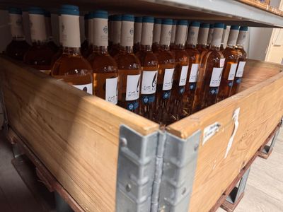 many bottles of wine sitting in a wooden crate