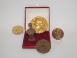 an image of a gold medal and other coins in a red box