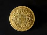 a close up of a gold coin with a coat of arms on it