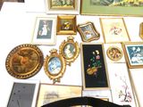 a table with a lot of framed pictures and pictures on it