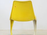 an image of a yellow chair sitting on top of a cement floor