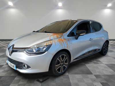 the silver car is painted with orange paint on the side of it