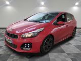 a red car is parked in a room with a checkered floor