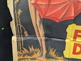 a poster of a woman holding an umbrella on the back of a truck