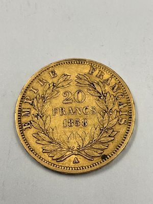 a close up of a gold coin on a white surface