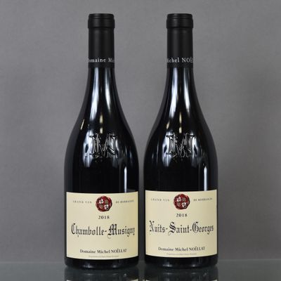 two bottles of wine sitting on top of a table next to each other
