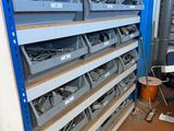 many bins that are on the shelves in the room